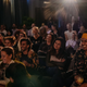 A packed crowd at The Williamsburg Hotel enjoys a live Gold Comedy showcase of top female comedians.